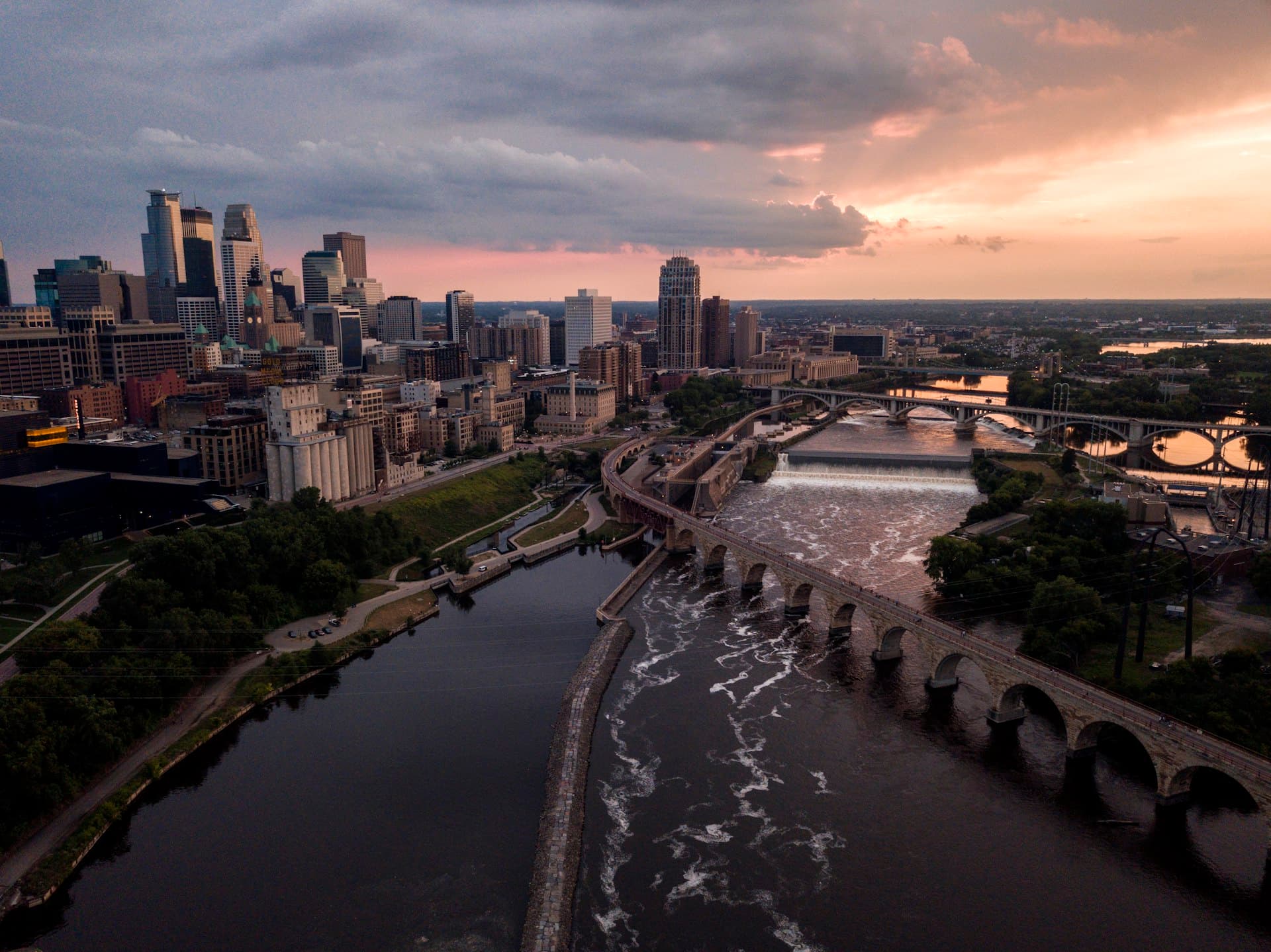Minneapolis skyline at sunset with Stone Arch Bridge